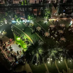 An aerial view of a festive outdoor evening event at Pullman New Delhi. This perspective shows the layout of the stage, dining area, and lighting design, demonstrating our ability to manage complex outdoor productions.