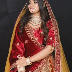 The rich maroon velvet and detailed embroidery on this bridal lehenga create a truly royal look. It's a perfect rental for a winter wedding.