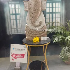 This is our modern abstract Ganesha sculpture, a contemporary take on a beloved deity. Carved from granite with a unique speckled finish, this 21-inch statue serves as a distinctive art piece for modern homes, gardens, or office spaces.