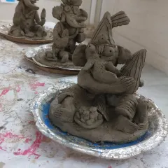 A close-up of the finished clay Ganesha idols, each with its own personality. You can see the little details, from the modaks to the expressions, that the kids added themselves.