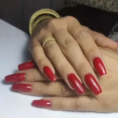 A vibrant, classic red on long, coffin-shaped nails. This is a go-to look for instant glamour.