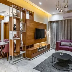 This open-plan living and dining area demonstrates our use of geometric shelving as a stylish, non-obstructive partition. The design maintains a sense of connection between the spaces while providing functional display storage.