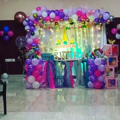 A full view of Swara's unicorn party setup. I used a mix of purples, pinks, and whites, with unicorn foil balloons and themed table skirting to create a cohesive and enchanting look.