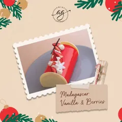 My Madagascar Vanilla & Berries Bûche is a festive delight, with a vibrant red glaze, delicate white chocolate snowflakes, and fresh strawberries.