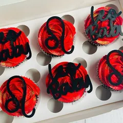 I love making birthdays personal with these custom zodiac cupcakes. This set for a Leo features rich chocolate cupcakes with bold red buttercream, a hint of gold glitter, and striking black acrylic toppers of the Leo symbol and "Leo Baby" text.