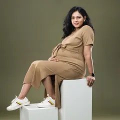 A cool and casual maternity look. Pairing a comfortable dress with sneakers shows that maternity photos can reflect your personal, everyday style.