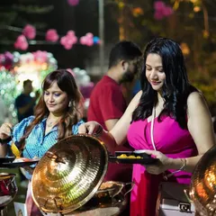 Guests enjoying the buffet at an outdoor birthday party. We love seeing people delight in the food we've prepared, creating a warm and happy atmosphere for any celebration.