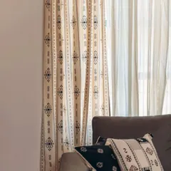 Our tribal-inspired Gypsy print curtain is layered with a Spear Sheer. The monochrome palette and geometric patterns create a bold yet refined look that works well in modern homes.