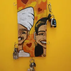 A custom caricature keychain holder featuring a couple in traditional attire. It's a beautiful and functional piece of art for your home.