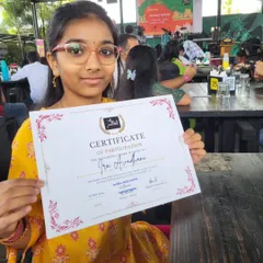 A happy student proudly displays her Certificate of Participation after performing at our concert. I believe in recognizing and celebrating every student's effort and courage.