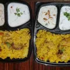 Indulge in our specialty meals like this aromatic Chicken Biryani combo. Each box comes with fragrant, long-grain biryani rice, tender chicken, cooling raita, and a delightful sweet dish, making it a complete and fulfilling meal.