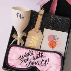 Celebrating the bride-to-be should be fun and personal. This hamper is all about pampering her with a custom 'Mrs' wine glass, a cheeky sleep mask, and a personalized luggage tag for her honeymoon adventures.