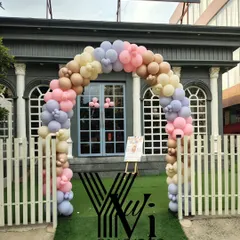 A beautiful pastel balloon arch at the entrance of a venue for a baby shower, creating a welcoming sight for guests.