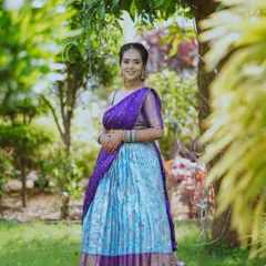 Our beautiful client looks absolutely radiant in this custom-fit South Indian half saree, or Langa Voni. We love combining traditional fabrics with modern designs to create the perfect outfit for your special cultural events.