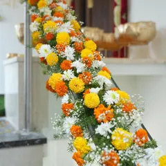I love decorating every part of the home. This staircase is adorned with a beautiful garland of marigolds and white chrysanthemums for a housewarming.