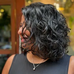 Another angle of this beautiful bob. The layers are cut to encourage the natural wave pattern, creating a soft, textured look.