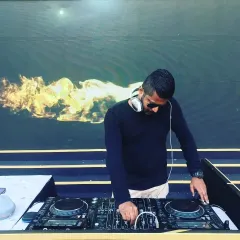 A clear shot of me at my outdoor setup, fully focused on the mix. I use a Pioneer DDJ controller, a standard for professional mobile DJs, ensuring reliability and great sound quality.