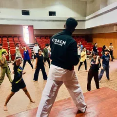 Leading a large group of students at our NIFT self-defense seminar. We teach practical skills to big groups, ensuring everyone learns to be safer.