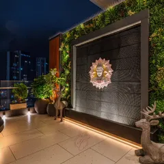 Another view of the Buddha water wall, showcasing the beautiful texture of the wall and the soft glow of the ambient lighting. This is a perfect spot for evening meditation or relaxation.