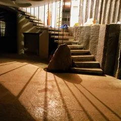 This is where stone and shadow create drama. We used a large, natural boulder as an anchor for this stone staircase, and the strategic lighting casts long shadows, turning a simple flight of stairs into a powerful architectural statement.