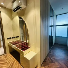 This bedroom wardrobe, finished in a high-gloss laminate, is paired with a matching dressing table. The seamless design creates a cohesive and luxurious personal space, showcasing my ability to craft integrated furniture solutions.