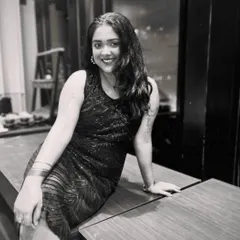 A smiling portrait from the same black and white series for "Tasveer". This photo shows a warmer, more approachable side while maintaining a chic aesthetic.