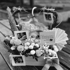 A black and white perspective of the friendship-themed birthday hamper, highlighting the textures of the rustic heart-shaped frame and the soft florals.