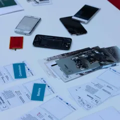 A collection of disassembled mobile phones and components laid out for a workshop. This hands on exploration helps kids understand the internal workings of the gadgets they use every day, from batteries to connectors.