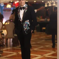 It’s a great feeling when a client’s vision comes to life. This custom black tuxedo features hand-embroidered lapels and a bold, colorful horse motif, showcasing the unique and personal designs we can create together.