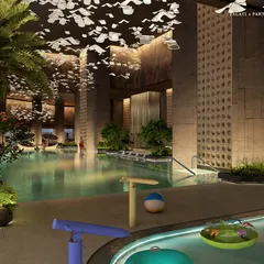 At Palais Royale, poolside leisure is paired with resort ease and metropolitan poise. A crystalline ribbon of water is framed by private cabanas and palm-lined greenery, creating a refined Tropicana vibe with a material palette of honed stone, warm wood accents, and softly gleaming metal details.