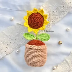 A full view of our potted crochet sunflower. It's the perfect, no-maintenance plant to brighten up your desk or any small corner.