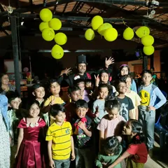 Surrounded by a happy crowd of kids after a fun-filled show. I always make time for photos with the audience after the performance.