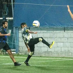 A player demonstrates excellent technique, controlling the ball with his chest during a TAL 7s League match.