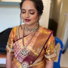 A close-up of the eye makeup for this engagement look. The warm, shimmery eyeshadow makes her eyes pop, while the perfectly sculpted brows frame her face beautifully.