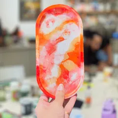 A vibrant and fiery abstract resin tray. The way the colors blend and create unique patterns makes every resin piece a one-of-a-kind work of art.