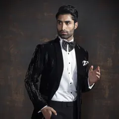 Shine bright and stand out. This stunning black sequined tuxedo is ideal for evening events, making a bold statement while maintaining a sophisticated silhouette.
