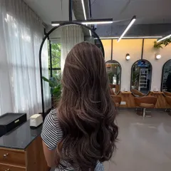 Another angle of this lived-in brunette look, showing how the highlights are placed to create dimension and movement throughout the hair.