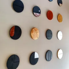 We believe in adding a personal touch to our spaces. These circular wall art pieces were designed and crafted in our own studio for a client's home. Made with wood, vegetable dyes, and gold and silver leaf, they represent the phases of the moon and add a layer of bespoke artistry to the interior.