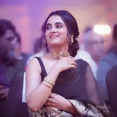 A candid photograph of actress Priyanka Mohan seated in the audience at an event. I focus on capturing natural, unposed moments that show a different side of public figures.