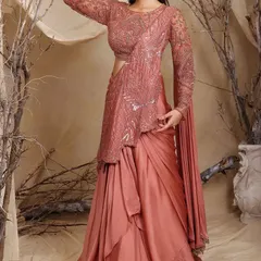 This rose-dust drape lehenga-saree shows how I blend traditional grace with modern structure. It's a powerful, confident look featuring hand-embellished sequins and a fluid silhouette.