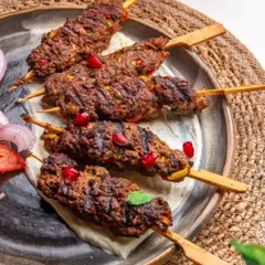 The right plate makes all the difference. Here, my rustic, dark-glazed platter provides the perfect canvas for presenting these delicious kebabs, enhancing the visual appeal of the food.