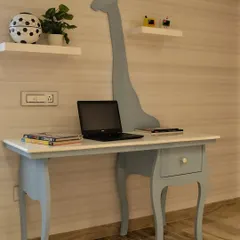 The study area from the same kids' room, featuring a whimsical giraffe silhouette integrated into the desk design, making homework time a little more fun.