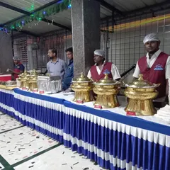 Our staff stands ready at a fully arranged buffet line at SSR Function Hall. We use traditional golden serving dishes to add a touch of class to the wedding feast, ensuring food is kept warm and served professionally.