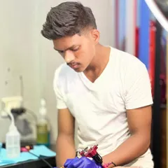 Artist Pravin focused on his craft. His steady hand and attention to detail are what make our tattoos stand out.