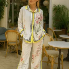 Showcasing the versatility of our classic white slides. They work beautifully with this vibrant, floral print co-ord set with yellow accents. This is the kind of easy-wear summer sandal that you can mix and match with countless outfits, from bold prints to simple solids.