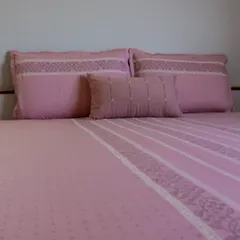 Our blush pink bedding set, crafted from soft cotton with delicate embroidered details. The subtle patterns and gentle color create a serene and romantic atmosphere, perfect for a peaceful night's rest.