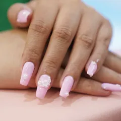 Timeless elegance with a modern twist. Our French gel nails feature a glossy finish and can be customized with delicate 3D floral charms for a touch of subtle glam.
