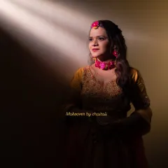 An artistic shot highlighting the soft and radiant makeup under dramatic lighting. The look is versatile enough for both candid and professional photoshoots.