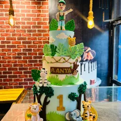I love bringing big ideas to life, like this towering three-tier jungle safari cake for a first birthday. It features handmade fondant animals like a lion, elephant, and zebra, creating a wild adventure that's completely edible and 100% eggless.