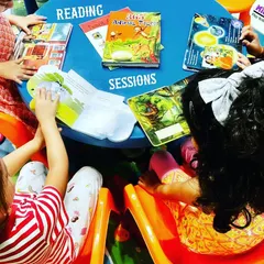 A group of children gathered for a reading session in our playschool. We create a dedicated and inviting space to encourage kids to explore books and develop early literacy skills together.